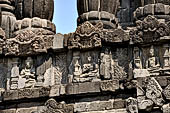 Prambanan - Candi Lara Jonggrang, miniature shrines surmounted by SMALL fluted stupa with panels with musicians and dancers decorating the top of the balustrade 